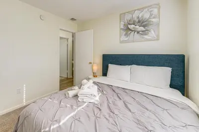 a bedroom with a large bed with a blue headboard at Gateway to Orlando Theme Parks! Home with Large Yard in Orlando