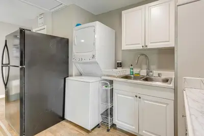 a kitchen with a refrigerator and a sink at Townhome with Fenced Yard in Orlando Suburbs! in Orlando