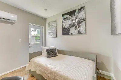 a small bedroom with a bed and a window at Townhome with Fenced Yard in Orlando Suburbs! in Orlando