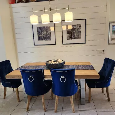 a dining room with a table and blue chairs at Mickeys Magical Escape in Orlando