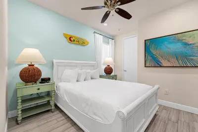 a bedroom with a white bed and a ceiling fan at A Parrot's Live For Me Cottage With Private Pool Near Disney With Margaritaville Resort & Island H20 Waterpark Access - 8028Sh in Orlando