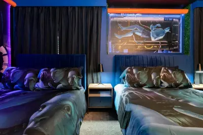 two beds in a room with purple and blue at Brand New 9 Bedroom Single Family Storey Lake 18ST in Kissimmee