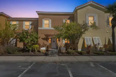 a house with a parking lot in front of it at Modern Kissimmee Townhouse near Disney townhouse in Kissimmee
