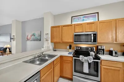 a kitchen with a sink and a microwave at Modern Kissimmee Townhouse near Disney townhouse in Kissimmee