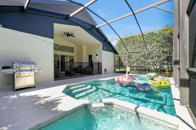 a swimming pool in the middle of a house at Luxury Villa, Welcome to EDC, Pool & Spa in Orlando