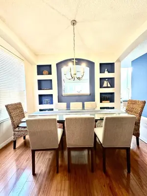 a dining room with a table and chairs at Disney Pixie Dust Villa in Kissimmee