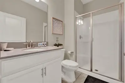 a white bathroom with a toilet and a shower at TVPM-4981WA/SL in Kissimmee