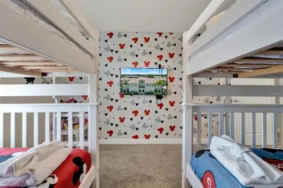 a bedroom with two bunk beds and a tv on the wall at TVPM-4981WA/SL in Kissimmee