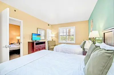 a hotel room with two beds and a television at 1BR Condo w Hot Tub & Pool Close to Universal Studio in Orlando