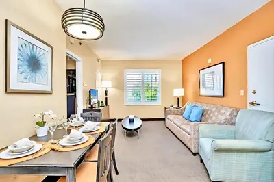 a living room with a couch and a table at Family-Friendly 1BR Apartment close to Disney World in Orlando