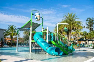 a water park with a slide in the water at Paradise Falls Stay for 13 in Kissimmee