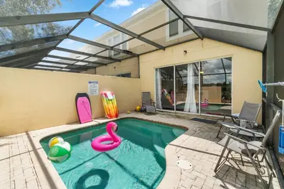 a swimming pool with a pink flamingo in a house at Disney Dream in Orlando