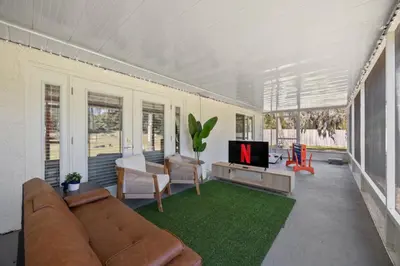a living room with a couch and a tv at Red Jordan Boho Style Vacation Home in Orlando