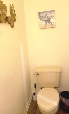 a bathroom with a toilet and a picture of a starfish at Orlando HomeDisney and beach in Orlando