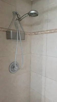 a shower with a shower head in a bathroom at Orlando HomeDisney and beach in Orlando