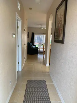 a hallway of a home with a tile floor at Spacious 4 BR Townhouse with 2 King Size Master Bedrooms, 3 miles to Disney, Free WiFi and Free Parking in Orlando