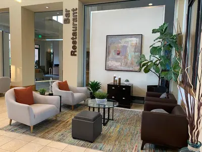 a lobby with couches and chairs and a table at Spacious 4 BR Townhouse with 2 King Size Master Bedrooms, 3 miles to Disney, Free WiFi and Free Parking in Orlando