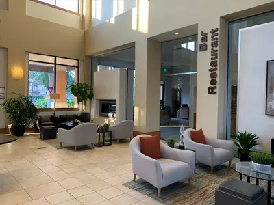 a lobby with couches and chairs in a building at Spacious 4 BR Townhouse with 2 King Size Master Bedrooms, 3 miles to Disney, Free WiFi and Free Parking in Orlando