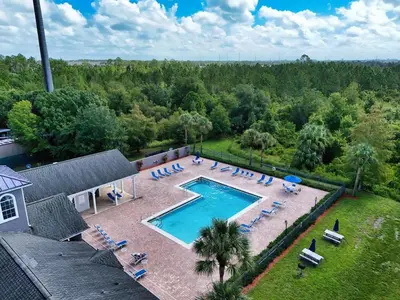 an overhead view of a swimming pool with chairs and trees at Secret Resort Kissimmee Lakeview Condo in Kissimmee