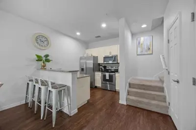 a kitchen with a counter and stools in a room at Magical Disney Getaway- Belle Potter & Minions in Kissimmee
