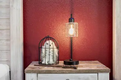 a lamp on a table next to a red wall at Magical Disney Getaway- Belle Potter & Minions in Kissimmee