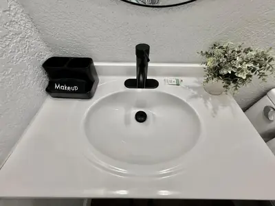 a white sink with a black faucet on a counter at Relaxing 3BR Home Near Orlando Downtown & Parks in Orlando