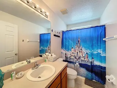 a bathroom with a sink and a bathroom shower curtain at Family Fun Tropical Home in Kissimmee