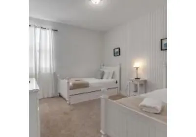 a white bedroom with a bed and a couch at 321 PC - Encore Oasis Luxury 5BR Home Private Pool in Orlando