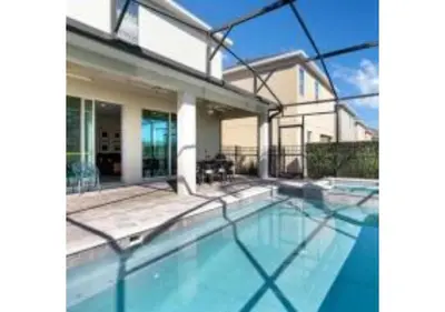 a swimming pool in front of a house at 321 PC - Encore Oasis Luxury 5BR Home Private Pool in Orlando
