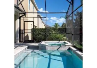 a swimming pool in front of a house at 321 PC - Encore Oasis Luxury 5BR Home Private Pool in Orlando