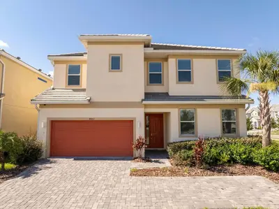 a large house with a red garage at Family Friendly 12Bd w Jacuzzi Veranda Palms 4401 in Kissimmee