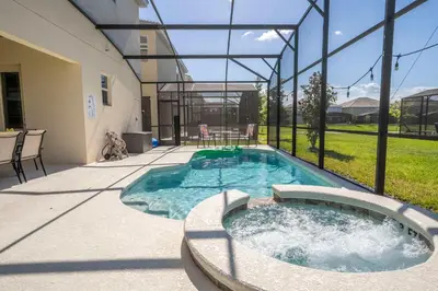 a hot tub in the backyard of a house at Family Friendly 12Bd w Jacuzzi Veranda Palms 4401 in Kissimmee