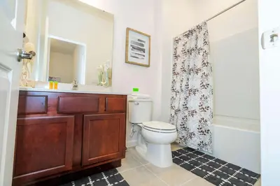 a bathroom with a toilet and a sink and a shower at Family Friendly 12Bd w Jacuzzi Veranda Palms 4401 in Kissimmee