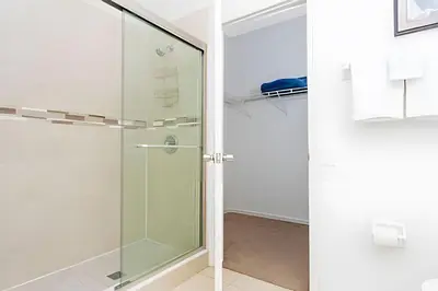 a shower with a glass door in a bathroom at Casa 4Q Disney c/ Piscina e Quartos Temáticos in Kissimmee