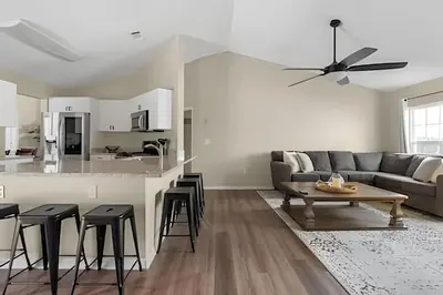 a living room with a couch and a table at Casa 4Q c/ Piscina e Game Room – Perto Disney in Orlando