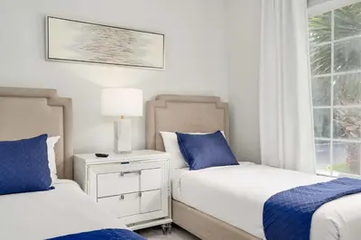 a bedroom with two beds and a window at Designer Retreat 2 Miles to Disney MP21 in Orlando