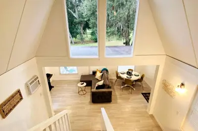 an overhead view of a living room with a large window at Lilac Loft- Lake, Pool, Pickle Ball, Disney, Fun! in Clermont