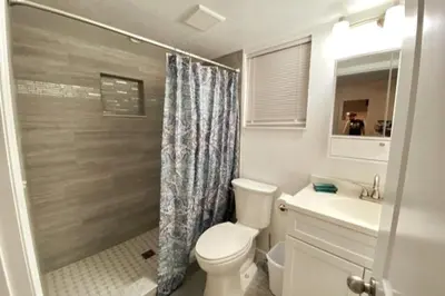 a bathroom with a toilet and a sink and a shower at Lilac Loft- Lake, Pool, Pickle Ball, Disney, Fun! in Clermont