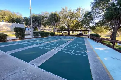 a tennis court with a net on it at Lilac Loft- Lake, Pool, Pickle Ball, Disney, Fun! in Clermont