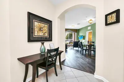 a dining room and living room with a table and chairs at LOCATION - Clubhouse & Pool in Orlando