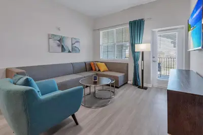 a living room with a couch and a table at WOW New Upscale Penthouse in Orlando