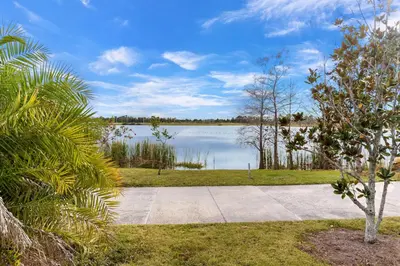 a view of a lake with trees and a sidewalk at Penthouse Corner at Vista Cay in Orlando