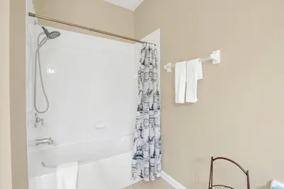a bathroom with a shower and a bath tub at Vista Cay Penthouse Luxury in Orlando
