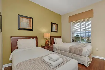 a bedroom with two beds and a window at Vista Cay Penthouse Luxury in Orlando