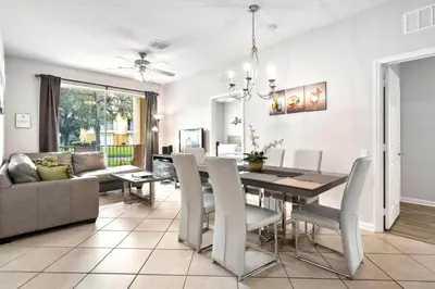 a dining room and living room with a table and chairs at Vista Cay Remodeled WOW in Orlando
