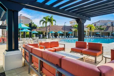 a patio with chairs and a swimming pool at Vista Cay Remodeled WOW in Orlando