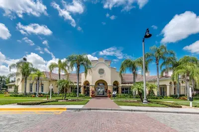 a building with palm trees in front of it at Vista Cay Remodeled WOW in Orlando