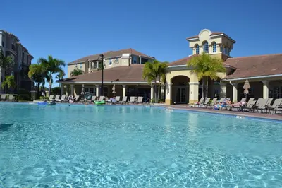 a large swimming pool in front of a building at Lake Front huge by clubhouse in Orlando