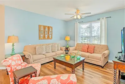 a living room with two couches and a table at Huge Updated Stunner Corner in Orlando