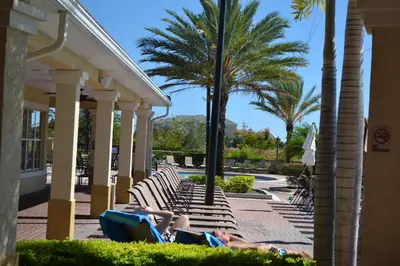 a group of people laying on lounge chairs at a resort at Huge Updated Stunner Corner in Orlando